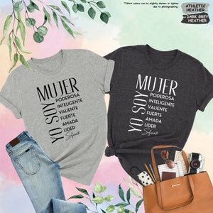 a couple of shirts that are next to a purse