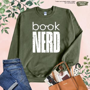 a book nerd sweatshirt, jeans, purse, and handbag