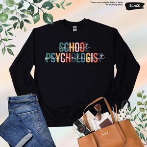 a black sweatshirt with the words school psychic on it
