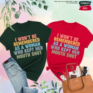 two t - shirts that say i won't be removed as a woman who