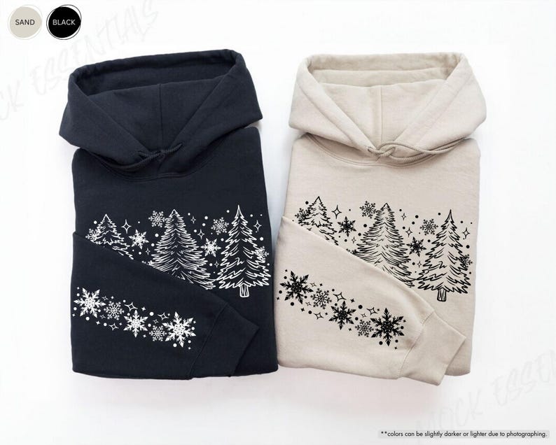 May include: Two hooded sweatshirts with a wintery design of trees and snowflakes. The sweatshirts are available in black and sand colors.