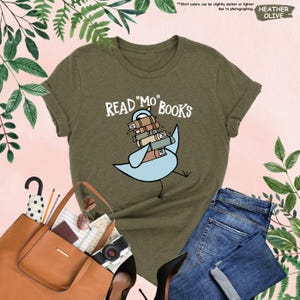 a t - shirt that reads read me books with a bird on it