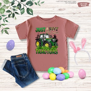 a pink shirt that says just a boy who loves tractors