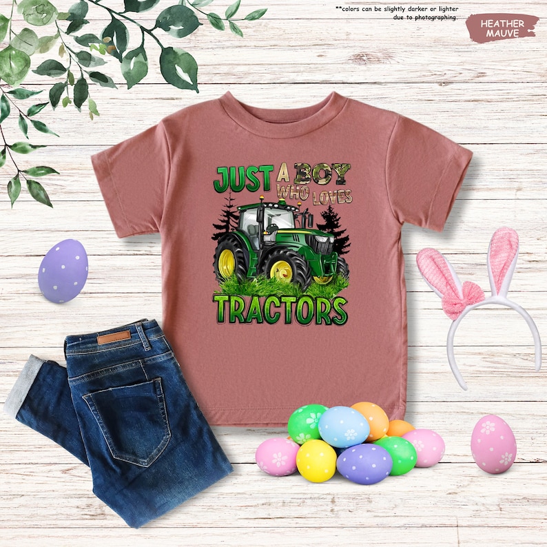 a pink shirt that says just a boy who loves tractors