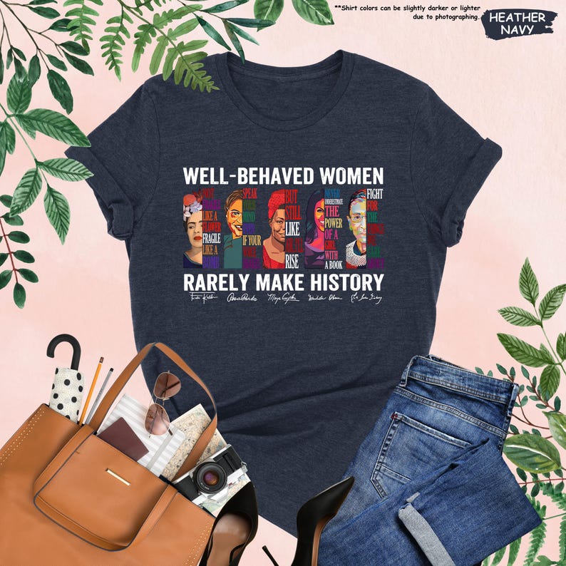 May include: A navy blue t-shirt with a graphic of famous women and the text "Well-behaved women rarely make history". The graphic includes portraits of Frida Kahlo,  Audre Lorde, Maya Angelou, Michelle Obama, and Ruth Bader Ginsburg. Each portrait is accompanied by a quote from the woman.