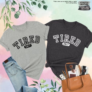 a couple of shirts that are next to a purse