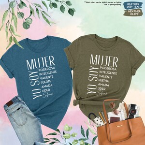 a couple of shirts that are next to a purse