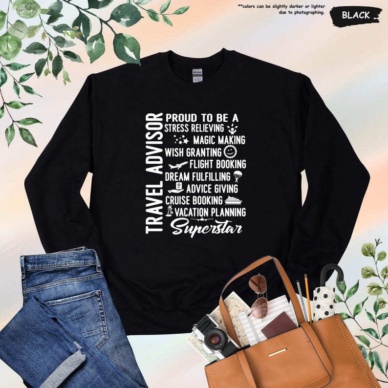 May include: Black long-sleeved sweatshirt with white text that reads "Travel Advisor Proud to be a Stress Relieving Magic Making Wish Granting Flight Booking Dream Fulfilling Advice Giving Cruise Booking Vacation Planning Superstar".