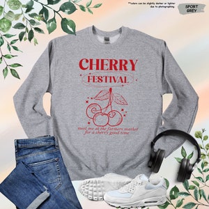 a sweatshirt with a pair of headphones and a pair of jeans