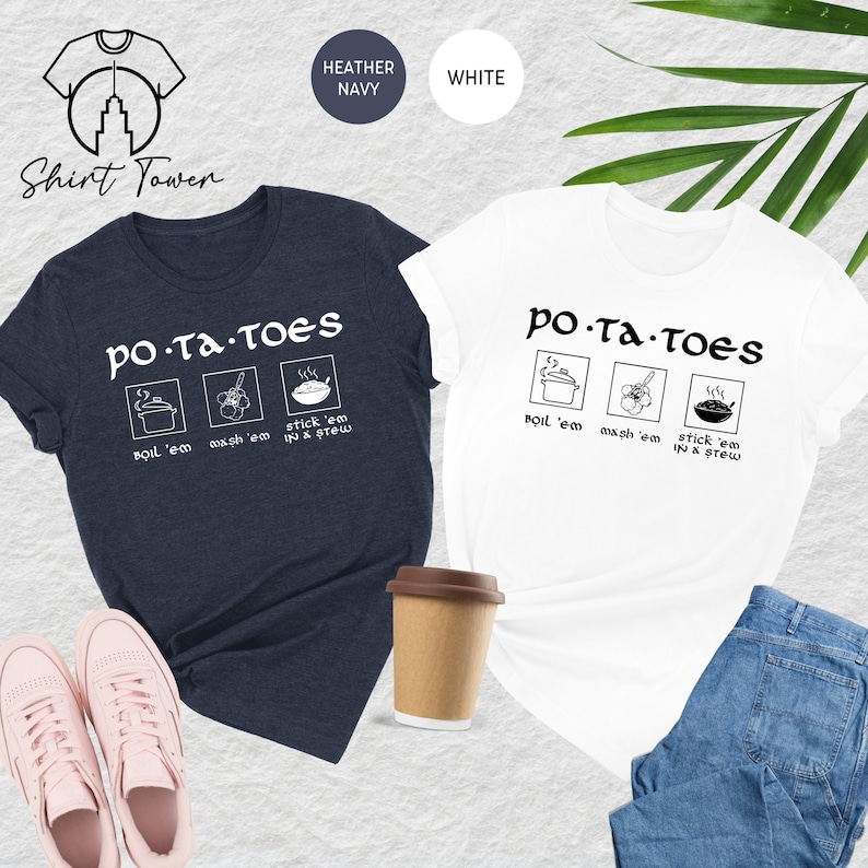 May include: Two t-shirts, one heather navy and one white, with the text 'PO-TA-TOES' and three icons depicting ways to prepare potatoes: boil 'em, mash 'em, and stick 'em in a stew.