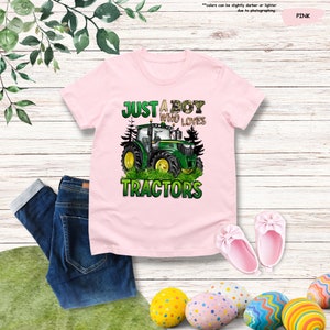 a pink shirt that says just a boy who loves tractors