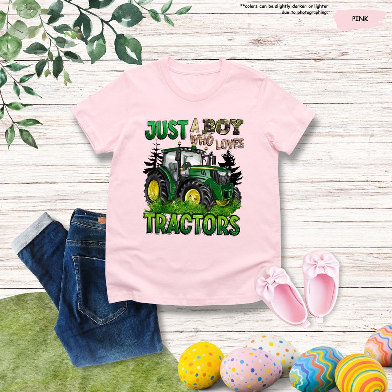 a pink shirt that says just a boy who loves tractors