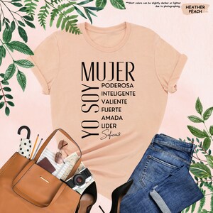 a t - shirt that says mujer and a purse next to it