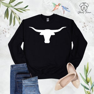 May include: Black sweatshirt with a white silhouette of a longhorn steer head with large horns.