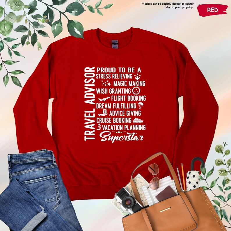 May include: Red long-sleeve shirt with white text that reads "Travel Advisor Proud to be a Stress Relieving Magic Making Wish Granting Flight Booking Dream Fulfilling Advice Giving Cruise Booking Vacation Planning Superstar".