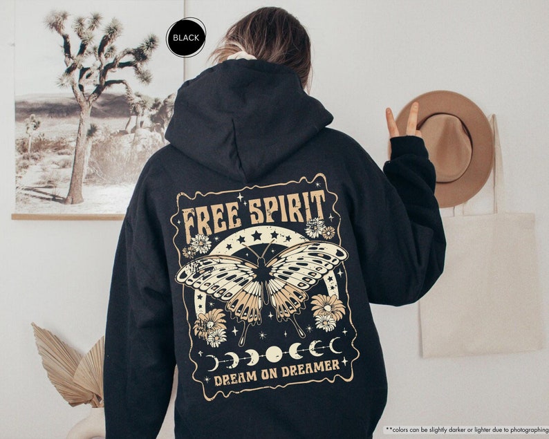 a person wearing a black hoodie with a picture of a butterfly on it