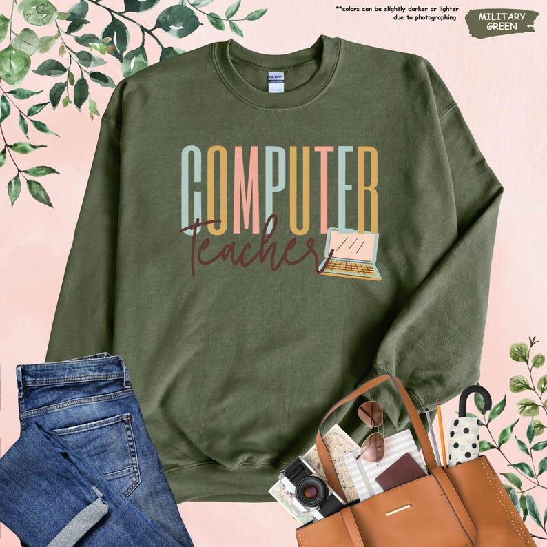 a green sweatshirt with the words computer teacher on it