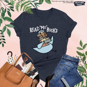 a t - shirt that reads read me books with a bird on it