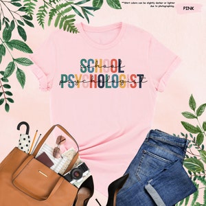 a pink t - shirt that says school psv holost next to a