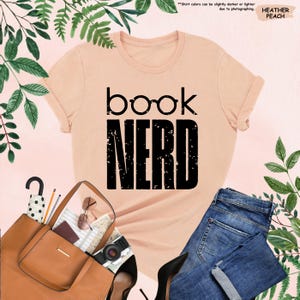 a t - shirt that says book nerd next to a handbag and purse