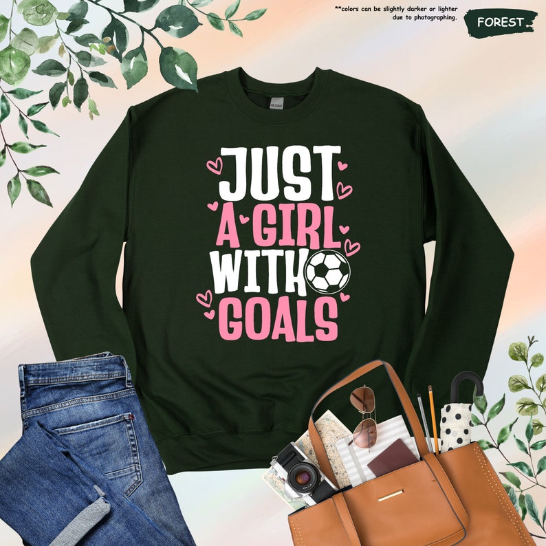 a sweater that says just a girl with goals on it