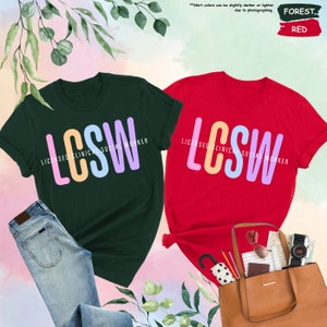 a couple of t - shirts that are next to a purse