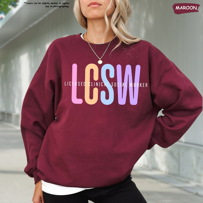 a woman with blonde hair wearing a maroon sweatshirt