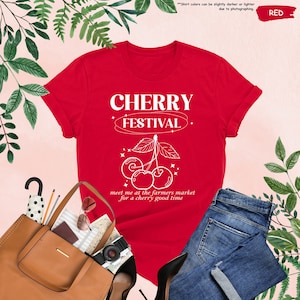 a red shirt with a cherry festival on it