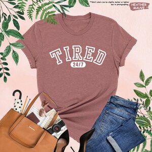 a women's t - shirt with the word tired on it