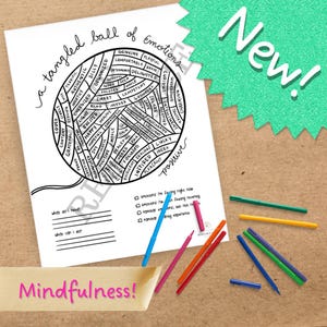 May include: A white paper with a black line drawing of a ball of emotions, with words like "happy" and "excited" inside. Colored pens and the word "Mindfulness!" are also visible.