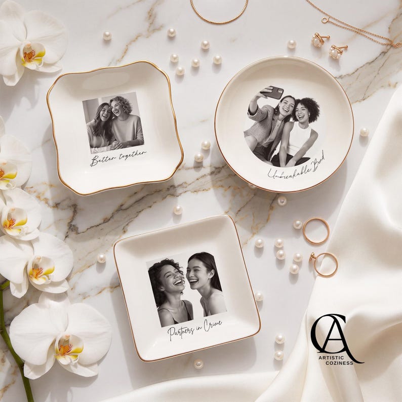 May include: Three white ceramic trinket dishes with gold-toned rims, each featuring a black and white photograph of two people. The dishes are inscribed with the phrases Better together, Unbreakable Bond, and Partners in Crime.