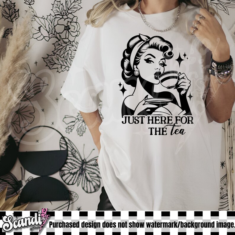 May include: White t-shirt featuring a black and white graphic of a woman drinking tea, with the text "JUST HERE FOR THE tea". The design has a vintage aesthetic with star accents.