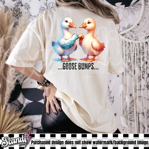May include: A white t-shirt with a design of two cartoon geese facing each other. The geese are holding hands and the text "...GOOSE BUMPS..." is printed below them.