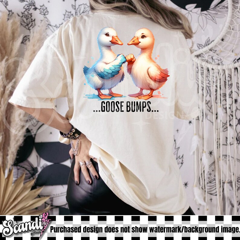 May include: A white t-shirt with a design of two cartoon geese facing each other. The geese are holding hands and the text "...GOOSE BUMPS..." is printed below them.