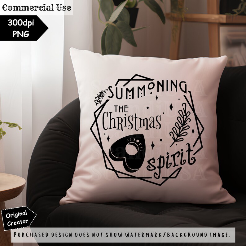 May include: A white pillow with a black design that says "Summoning the Christmas Spirit" with a black heart-shaped Ouija board in the center.