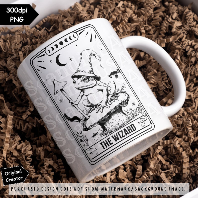 May include: White ceramic mug featuring a black and white illustration of a frog wearing a wizard's hat and holding a staff. The illustration is enclosed in a black border with the text "THE WIZARD" printed beneath the frog.