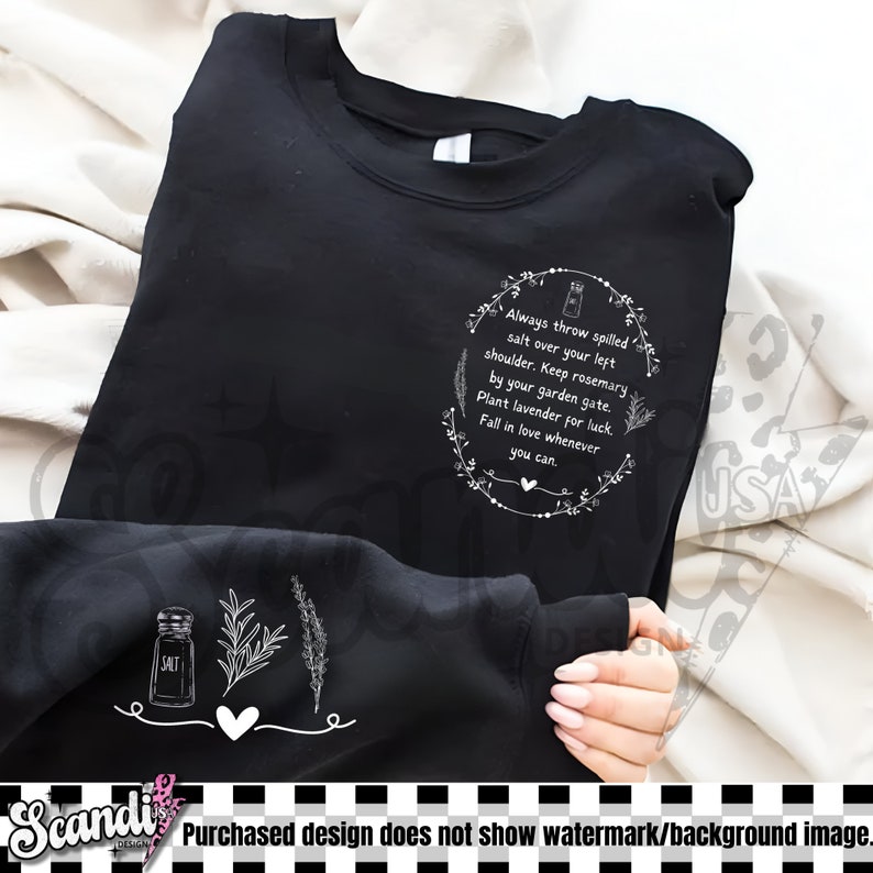 May include: Black sweatshirt with white graphic text and illustrations. The text reads "Always throw spilled salt over your left shoulder...Fall in love whenever you can." Features a salt shaker, herbs, and a heart.