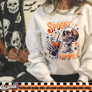 Op de afbeelding: Wit sweatshirt met een afbeelding van een skelet dat een drankje drinkt met de tekst "Spooky Summer" in oranje en zwart.