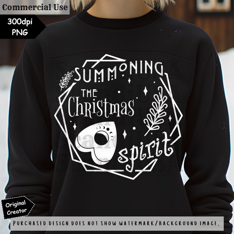 May include: A black sweatshirt with a white graphic design that says "Summoning the Christmas spirit". The design features a stylized Ouija board and a sprig of holly.