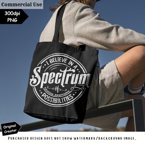 May include: A black tote bag with a white circle design that says "I believe in a spectrum of possibilities." The text "Autism Awareness" is also included in the design.