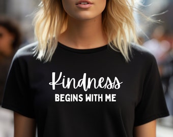 May include: Black t-shirt with white text that reads "Kindness Begins With Me".