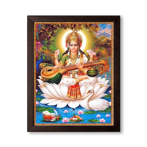 May include: A framed painting of Saraswati, the Hindu goddess of knowledge, music, and art. She is depicted playing a veena, a stringed instrument, while sitting on a white lotus flower. The painting is set against a colourful background with a peacock and a swan.