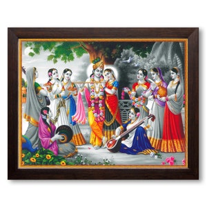 May include: A framed painting depicting a scene from Hindu mythology. The central figures are Krishna and Radha, surrounded by other figures playing musical instruments and holding flowers. The painting is done in a colorful style with a black and white background.
