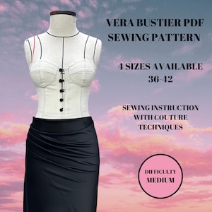 May include: A white bustier sewing pattern on a mannequin, paired with a black skirt. The image includes text: "VERA BUSTIER PDF SEWING PATTERN", "4 SIZES AVAILABLE 36-42", "SEWING INSTRUCTION WITH COUTURE TECHNIQUES", and "DIFFICULTY MEDIUM".