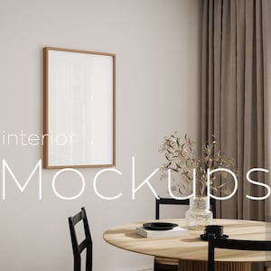 May include: A light brown wooden frame with a white poster inside, hanging on a white wall. The frame is in a dining room with a wooden table, chairs, and a vase of dried flowers.