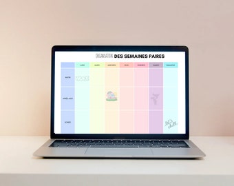 May include: A laptop screen displaying a weekly planner with a rainbow color scheme. The planner is titled "Organisation des Semaines Paire" and is divided into days of the week, with sections for morning, afternoon, and evening. The planner includes the text "Work" and "Let's chill".