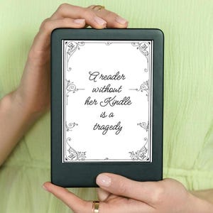 May include: A black and white Kindle e-reader with a quote on the screen that reads "A reader without her Kindle is a tragedy."