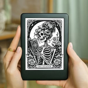 May include: A black and white illustration of a skeleton reading a book. The skeleton is wearing a crown of flowers and is surrounded by roses. The text "THE READER" is at the bottom of the image.
