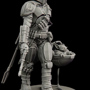 May include: A gray, detailed, 3D printed figurine of a Mandalorian warrior with a jetpack and a rifle. The Mandalorian is holding a small, gray, 3D printed figurine of a baby Yoda in a floating pod.