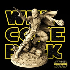 May include: A 3D printed model of a Mandalorian character from Star Wars, standing on a rocky base with a blaster in hand. The model is painted in a beige color and has a detailed design. The text "STAR WARS 3D MODELS" is visible in the lower right corner of the image.